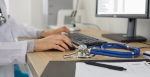 Doctor using AI-assisted EHR system on a tablet during patient consultation